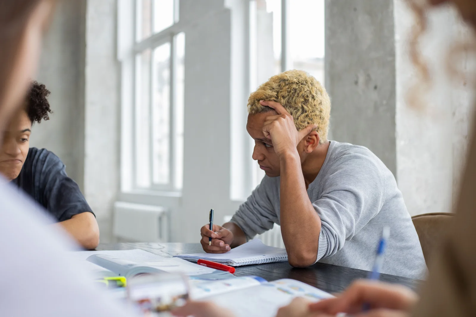 Adult learners taking notes during a study session